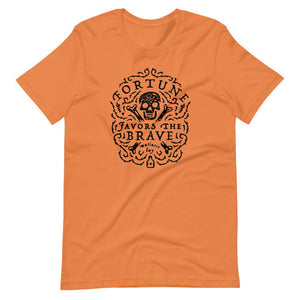 Burnt Orange short sleeve t-shirt with centered skull and cross bones, with small additional artistic accents, surrounded in a circular pattern with "Fortune Favors the Brave". All lettering and imagining is in Black.