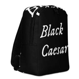 All over printed black backpack with "Black Caesar" written in White IM Fell font, in two horizontal lines across the back. Black Caesar (died 1718) was a legendary 18th-century African pirate. The legends say that for nearly a decade, he raided shipping from the Florida Keys and later served as one of Captain Blackbeard's, a.k.a. Edward Teach's, crewmen aboard the Queen Anne's Revenge