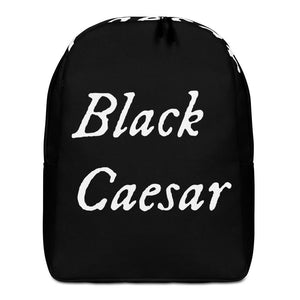 All over printed black backpack with "Black Caesar" written in White IM Fell font, in two horizontal lines across the back. Black Caesar (died 1718) was a legendary 18th-century African pirate. The legends say that for nearly a decade, he raided shipping from the Florida Keys and later served as one of Captain Blackbeard's, a.k.a. Edward Teach's, crewmen aboard the Queen Anne's Revenge